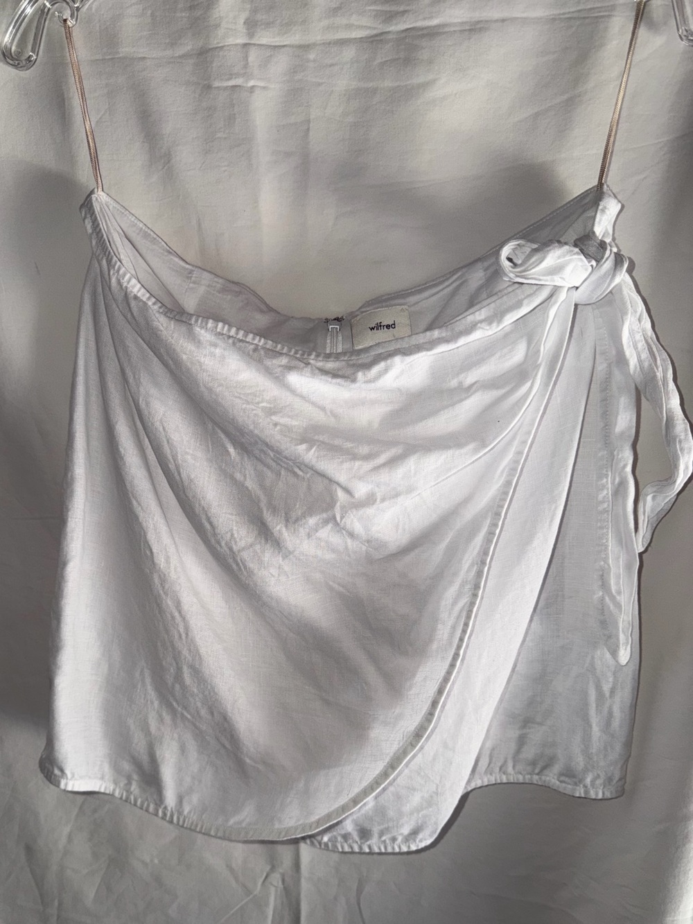 Wilfred white wrap-style top with a side tie closure.